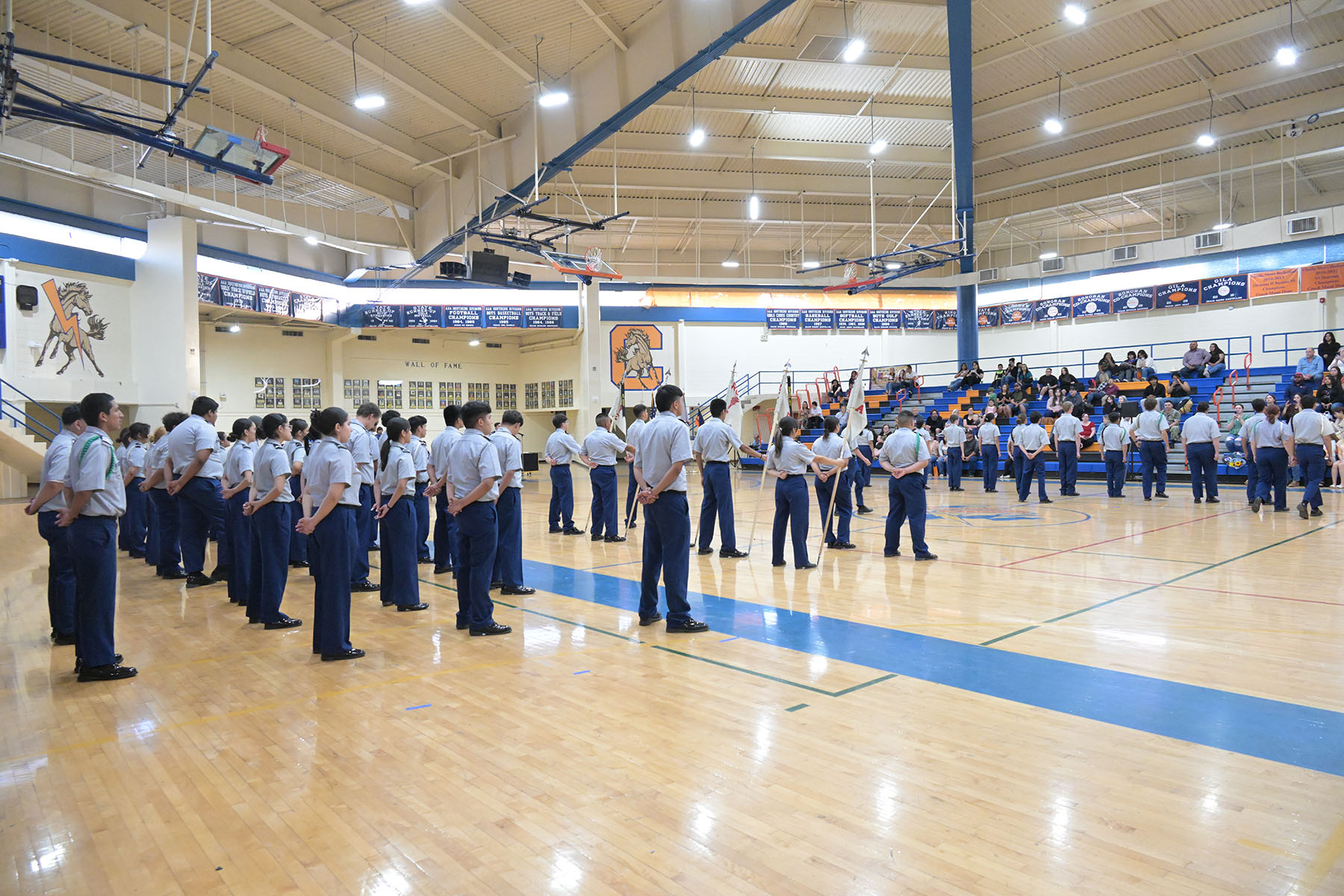JROTC cadets stand on the gym floor