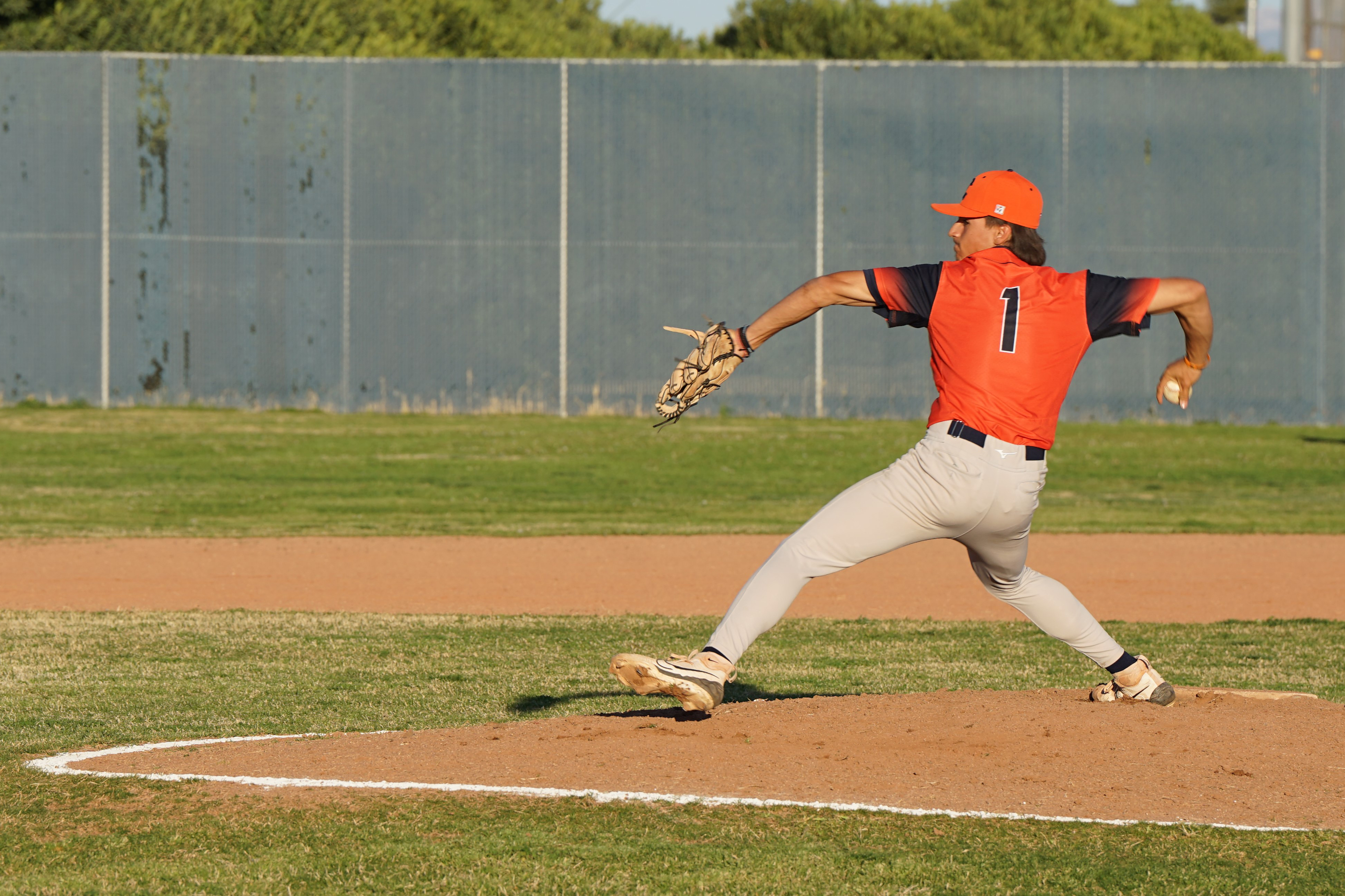 A baseball player throws out a pitch