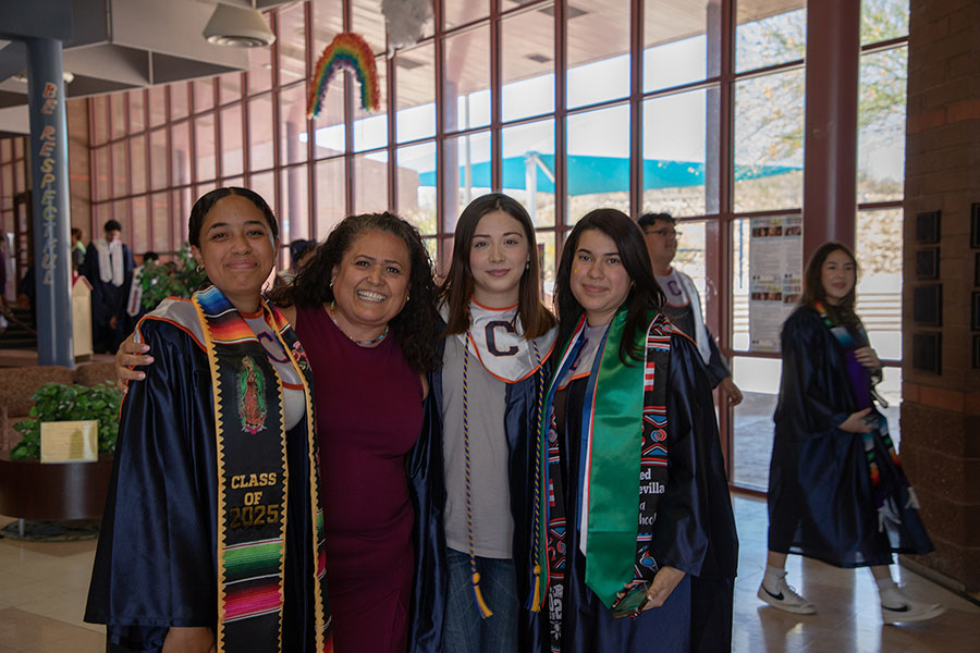 Three Cholla seniors pose with Johnson's principal