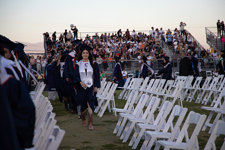 Graduates file into their seats on the field
