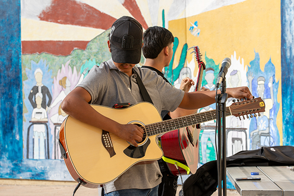Teen boys tune up their guitars before the performance