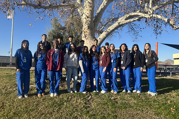 Cholla Sports Med students pose for a group pic under a tree
