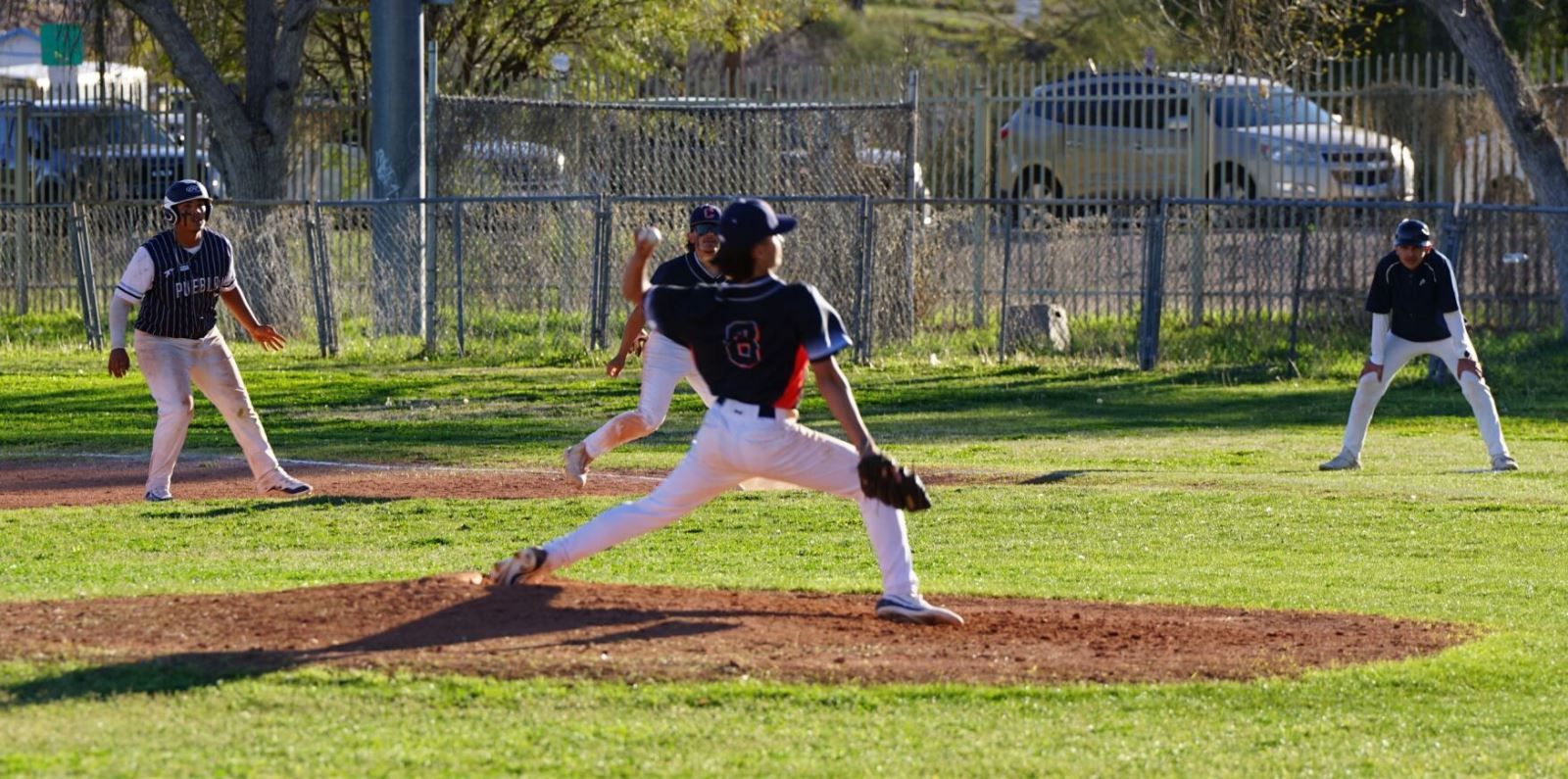 A Cholla baseball players throws out a pitch.